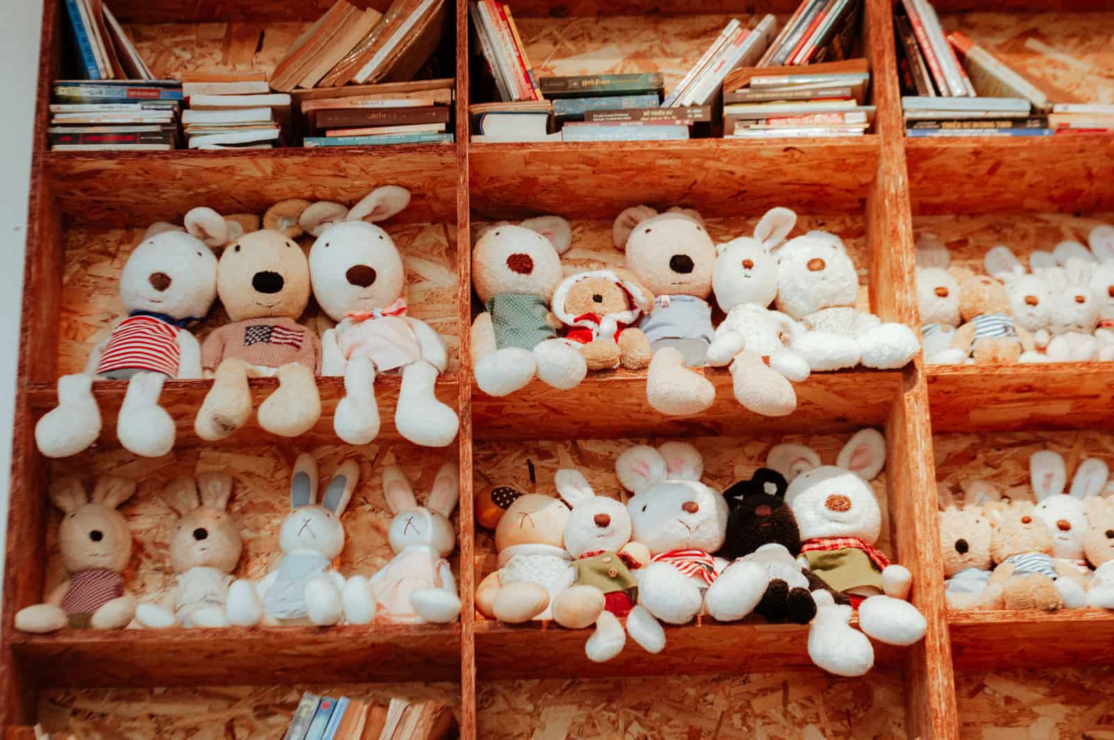 A low wooden shelf of toys in a child's room