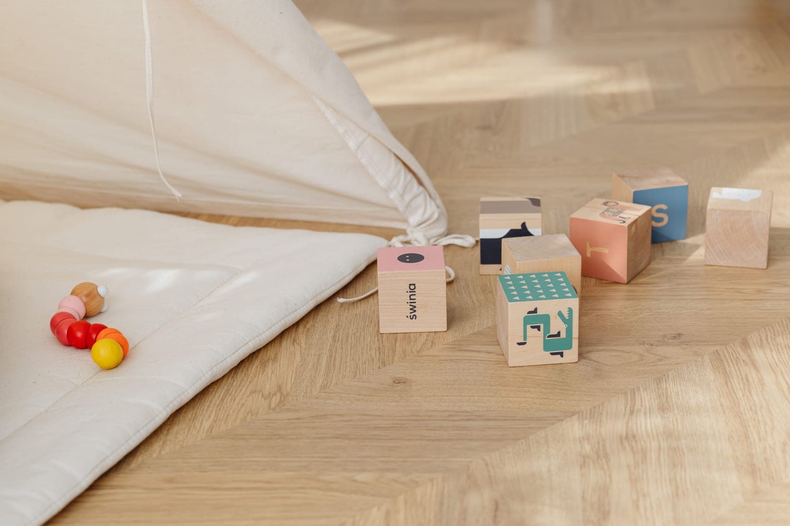 Toys scattered across a playroom floor mid-play